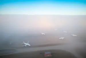 Eppley Airfield engulfed in dense fog with grounded planes.