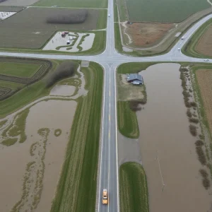 Flooded roads and fields in rural Iowa after rain.