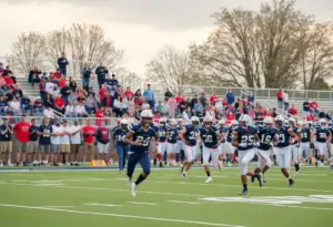 Millard South High School football team celebrating their win with fans cheering in the background.