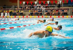 Swimmers from the UNO Swim and Dive Team in action during a relay event.